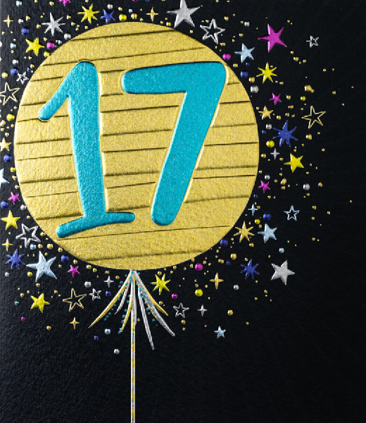 Black birthday card. A gold balloon with the number seventeen in the middle of the card surrounded by smaller stars.