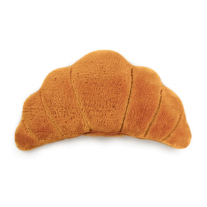 Plush eye pillow shaped like a croissant on a white background
