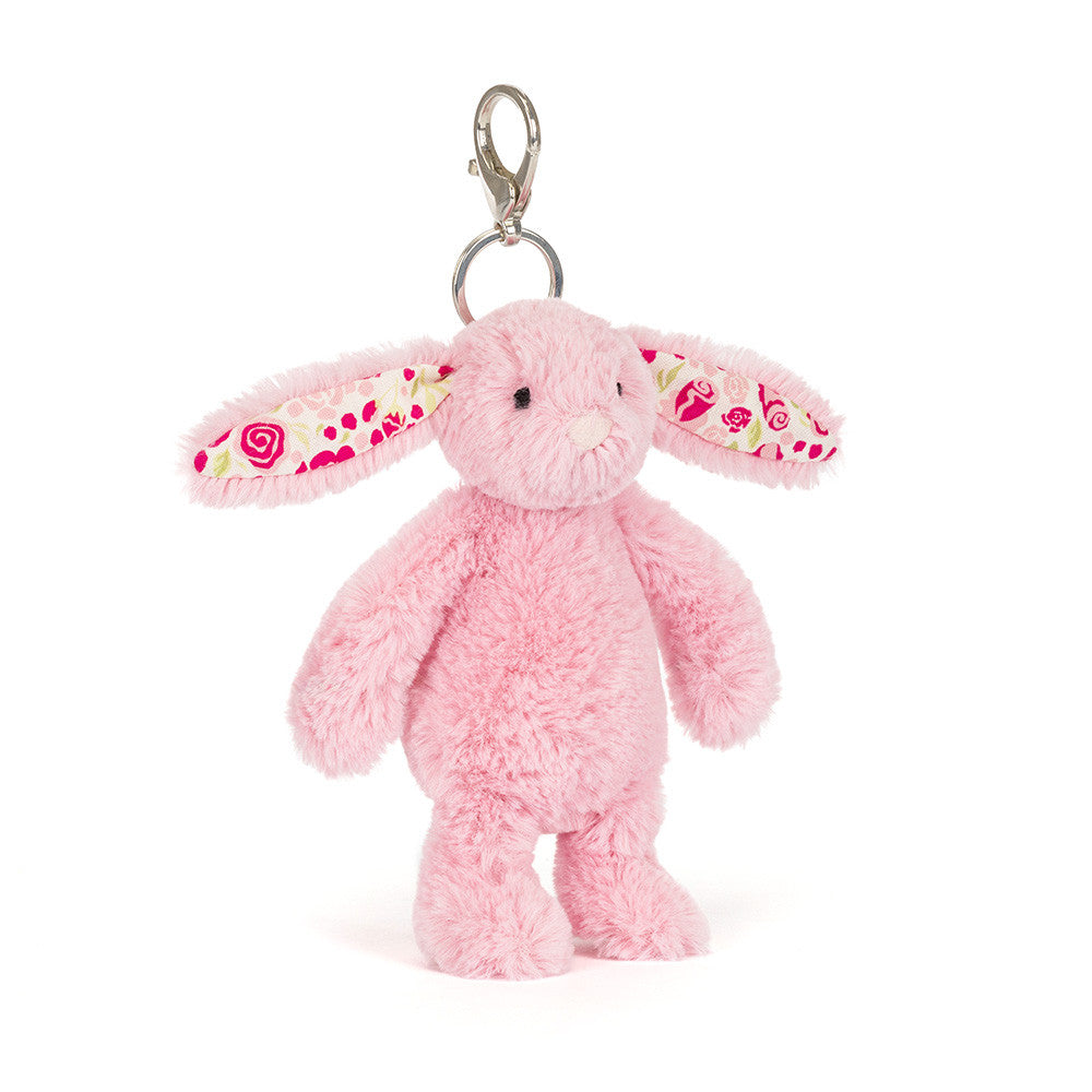 Pink plush bunny keychain with floral patterned lining on it's ears on a white background