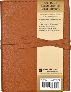 Back view of a brown vegan leather wrap journal with a tri-fold construction and a faux leather tie closure. The notebook also shows branded packaging on the back. 