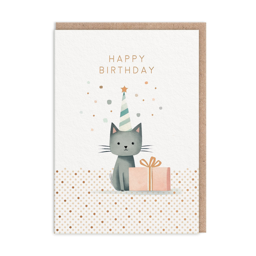 Greeting card with a grey cat wearing a party hat sitting beside a present, on a white and polka dot background. The card has text saying "Happy Birthday".
