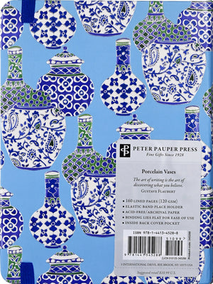 Back view of a midsize journal with a blue and white porcelain vases patterned cover and a blue elastic band. A sticker in the bottom right corner show's the company branding. 