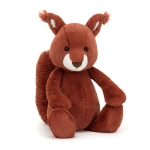 adorably soft plushie of a sitting red squirrel by popular brand Jellycat.