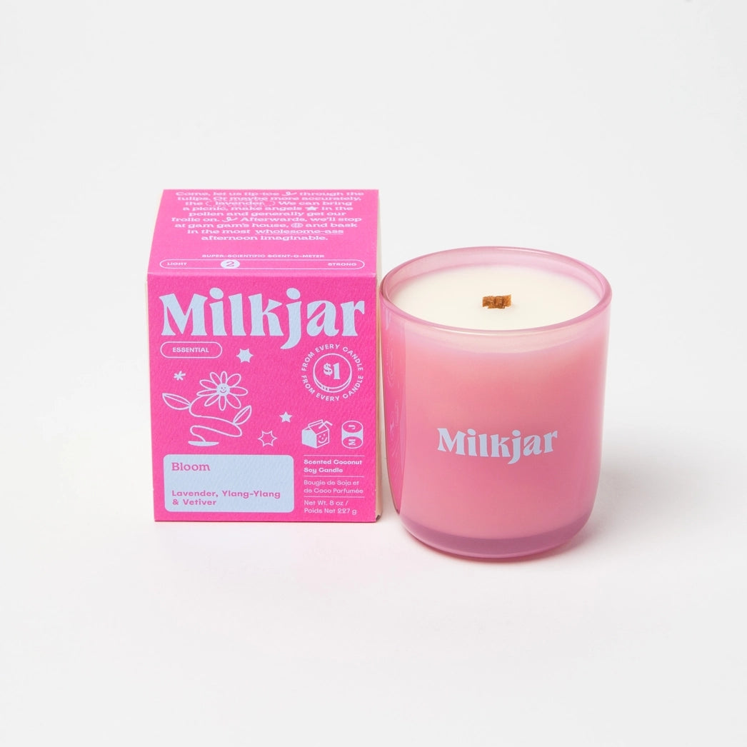 Pink Milkjar candle and packaging with purple branding on a white background.