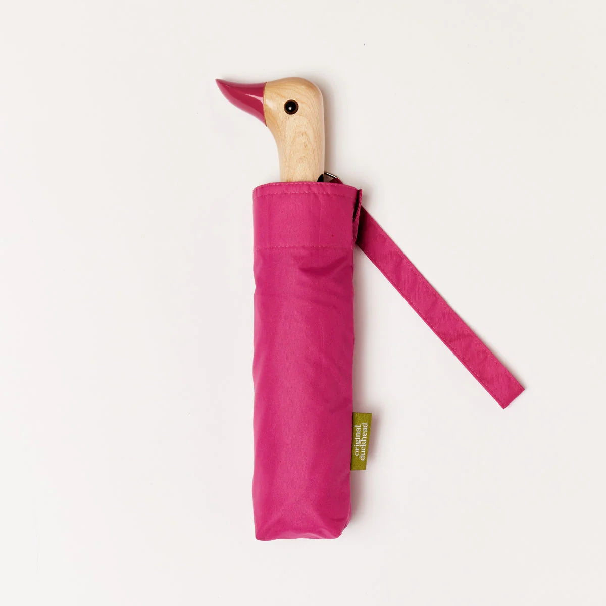 Pink umbrella with a wooden duck handle on a white background.
