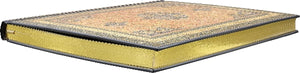 Hardback notebook lying flat with guilded gold page edges on a white background. 