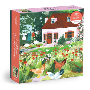 A jigsaw puzzle box featuring an illustration of a cottage with wildflowers and chickens outside.
