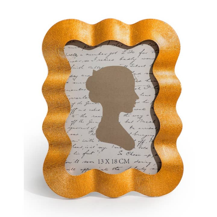 A gold rectangular shaped photo frame with a wavy shape and texture around the border. The image inside the frame shows the silhouette of a side profile.