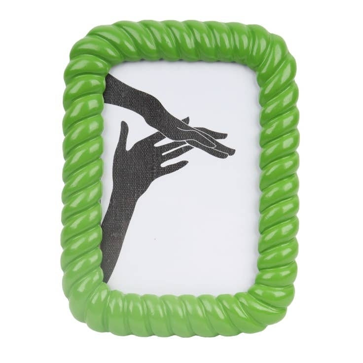 A green rectangular shaped photo frame with a rope style border. An image of the silhouttes of two hands sits inside the frame. 