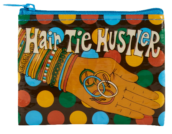 Coin purse with a hand holding hair ties and hair pins under the text "hair tie hustler". The background is brown with colorful circles.