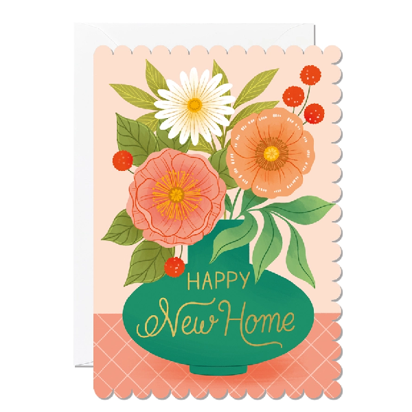 salmon new home card with rounded, hill-like sides. a green vase hold white, orange, red, and pink flowers. golden text on the vase reads "happy new home"