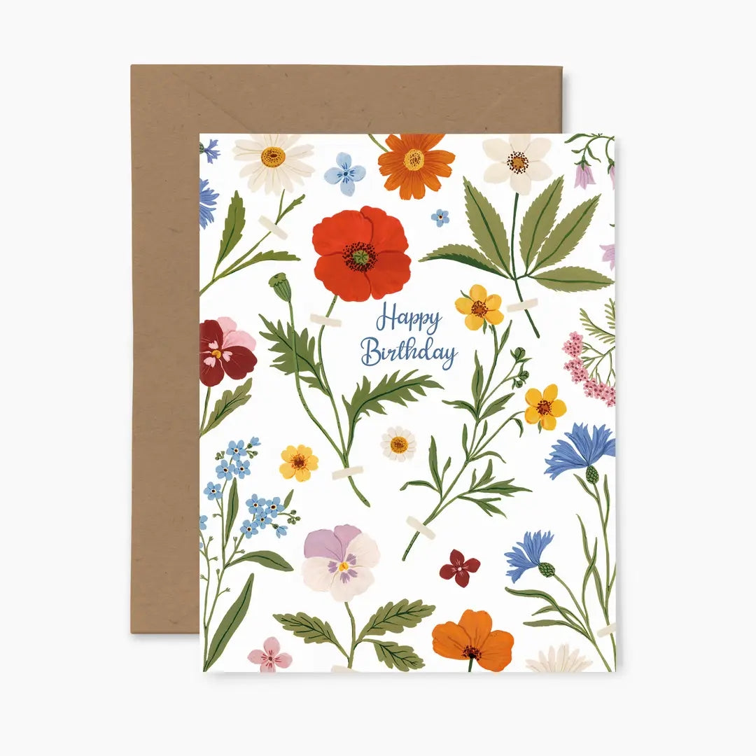 Greeting card featuring a colourful floral pattern on a white background with the text 'Happy Birthday' and a brown envelope.