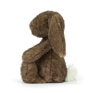 Side view of a Jellycat Brown plush bunny with a white fluffy tail on a white background