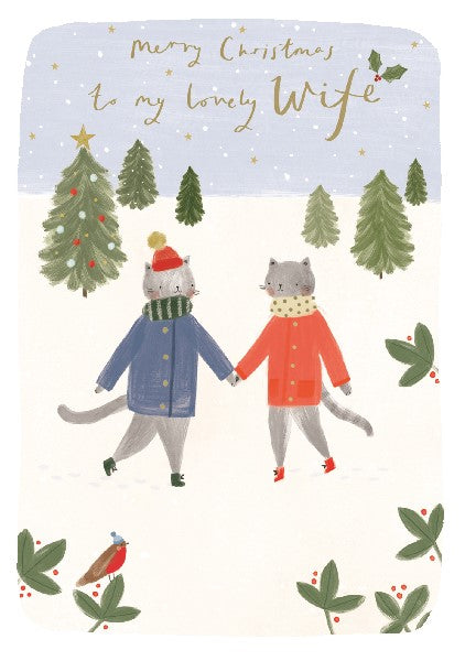 christmas card with two jacket-wearing cats holding hands in a snowy landscape. top text reads "merry christmas to my lovely wife"