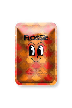 brown rectangular bag with "Flossie" written in black and a cartoonish facial expression at the centre. the flavour of the candy is written in a smaller font below the grimace. red, orange, and yellow maple leaves make up the background of the bag