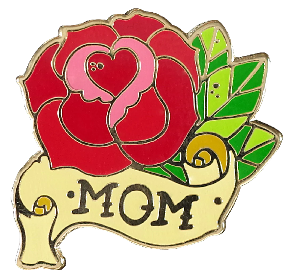 shape-cut enamel pin of a red rose with a heart at its core, leaves, and a parchement banner. the text on the banner reads "mom"