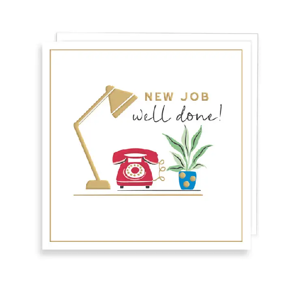 White new job card. Text "new job well done!" above a desk top with a lamp, phone, and plant. 