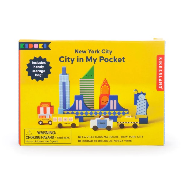 yellow rectangular package on a white background. pictures on the box are smiling and winking colourful, New York city-themed playing blocks. kikkerland product