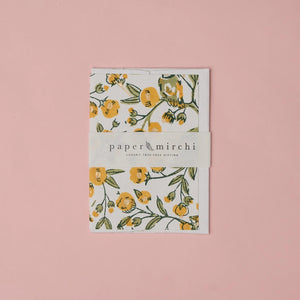 Cotton paper greeting card with a yellow, green and gold botanical and bird design on a white background. 