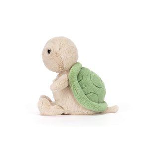 Side view of a Jellycat turtle plush on a white background