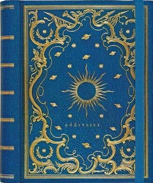 royal blue leather journal with intricate gold details such as planets and a sun in the centre. bottom text reads "addresses" in gold. an elastic band clasps the book vertically