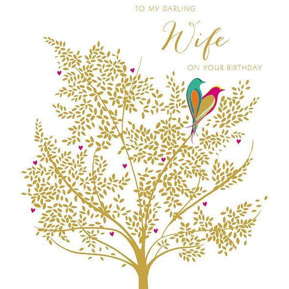 white birthday card. two birds form a heart with their silhouettes. they sit on a golden tree. top text reads "to my darling wife on your birthday"